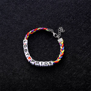 Top down view of an LGBT bracelet on a black surface