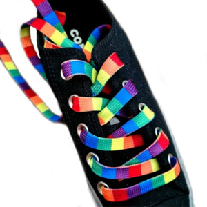 Rainbow striped shoelaces on a pair of black Converse